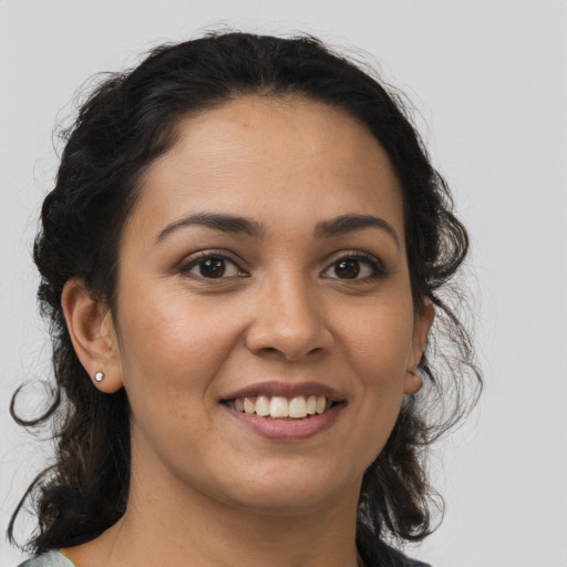 Joyful latino young-adult female with medium  brown hair and brown eyes