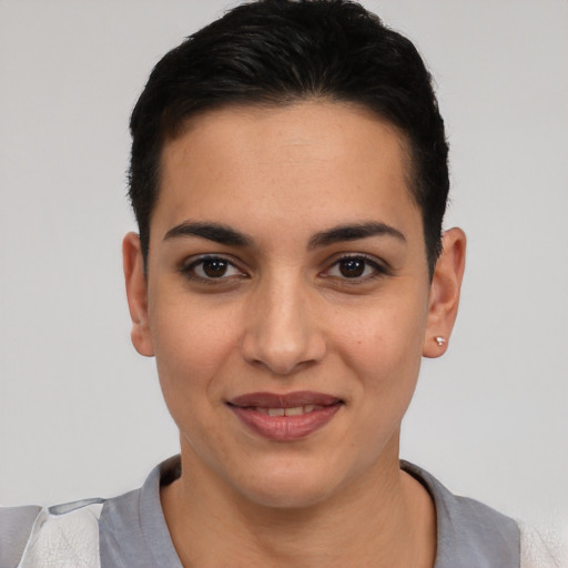 Joyful latino young-adult female with short  black hair and brown eyes