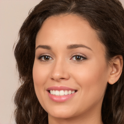 Joyful white young-adult female with long  brown hair and brown eyes