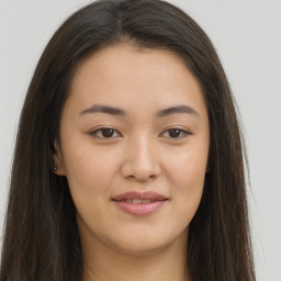 Joyful asian young-adult female with long  brown hair and brown eyes