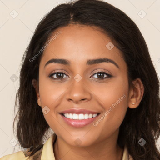 Joyful latino young-adult female with long  brown hair and brown eyes