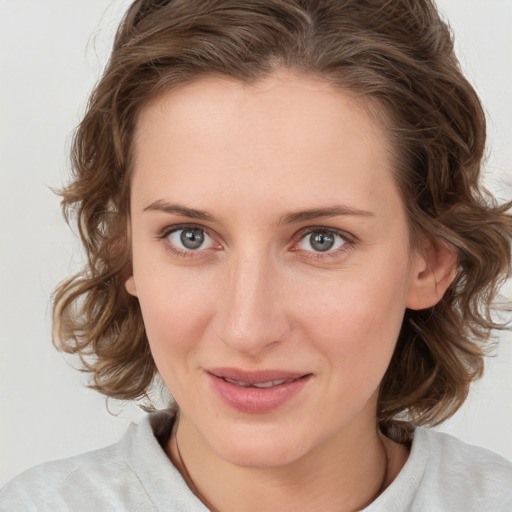 Joyful white young-adult female with medium  brown hair and blue eyes