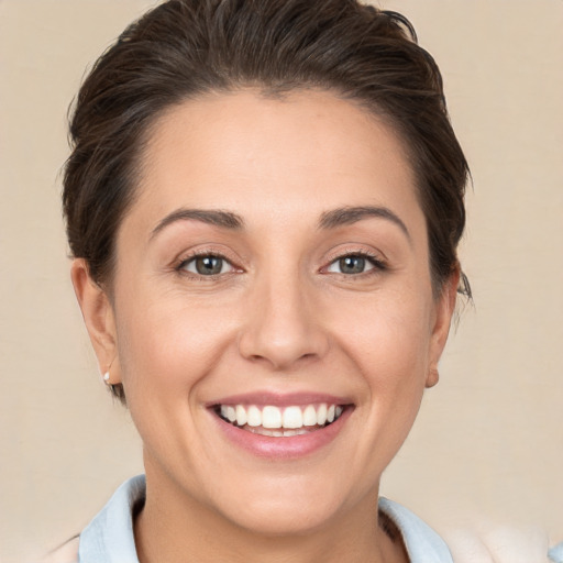 Joyful white young-adult female with short  brown hair and brown eyes