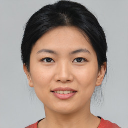 Joyful asian young-adult female with medium  black hair and brown eyes