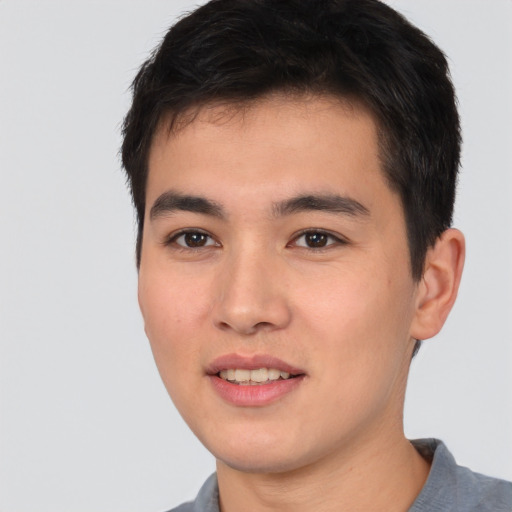 Joyful asian young-adult male with short  brown hair and brown eyes