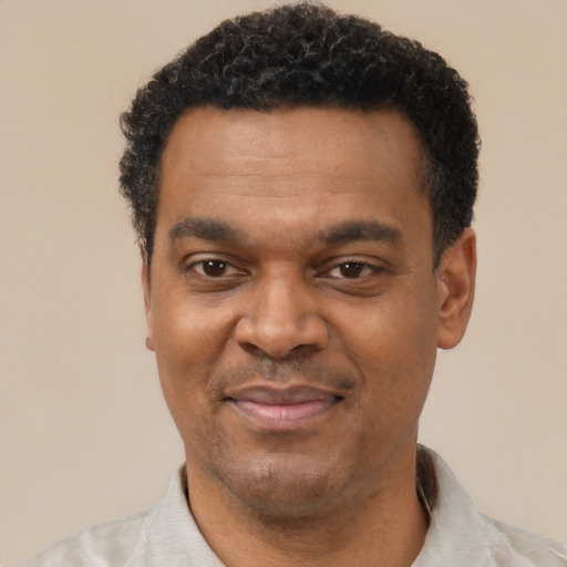 Joyful latino adult male with short  black hair and brown eyes