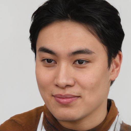 Joyful asian young-adult male with short  brown hair and brown eyes