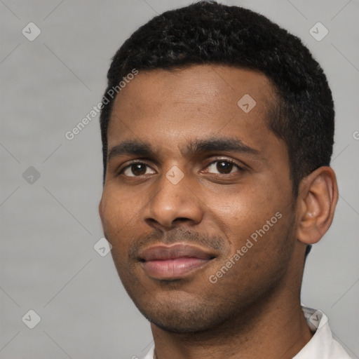 Joyful black young-adult male with short  black hair and brown eyes