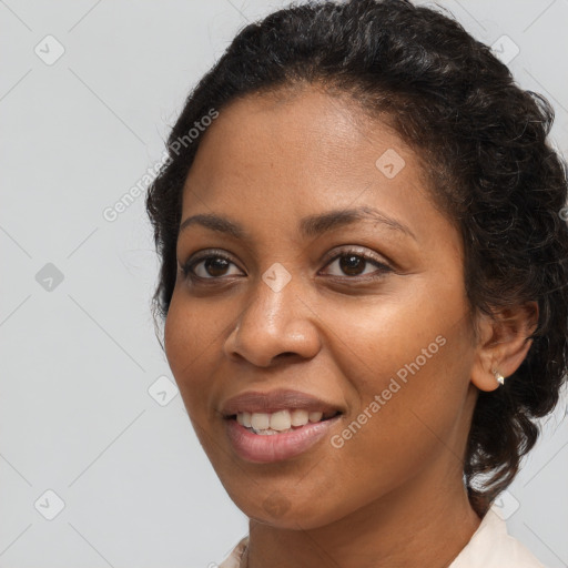 Joyful black young-adult female with long  brown hair and brown eyes