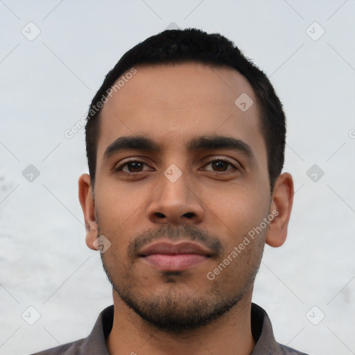 Neutral latino young-adult male with short  black hair and brown eyes