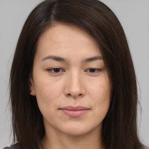 Joyful asian young-adult female with long  brown hair and brown eyes
