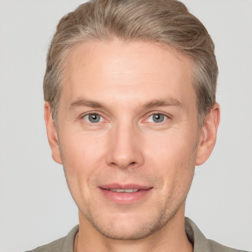 Joyful white adult male with short  brown hair and grey eyes