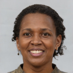 Joyful black adult female with short  brown hair and brown eyes