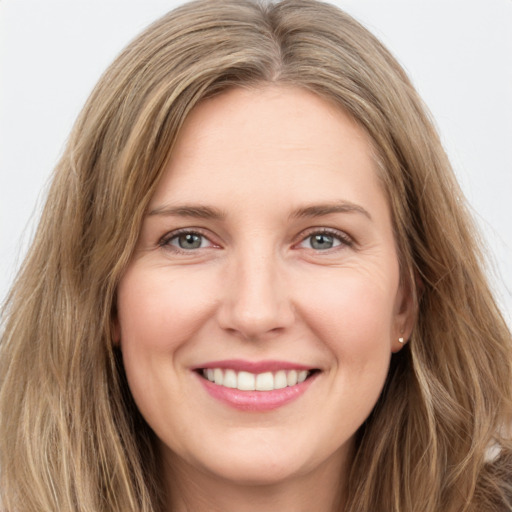 Joyful white young-adult female with long  brown hair and green eyes