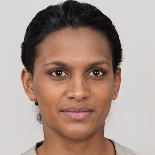 Joyful latino young-adult female with short  brown hair and brown eyes