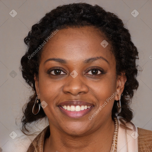 Joyful black young-adult female with long  brown hair and brown eyes