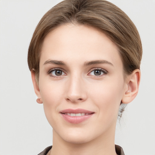 Joyful white young-adult female with short  brown hair and grey eyes