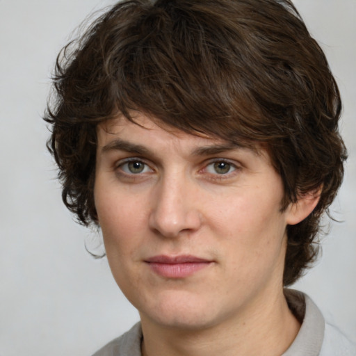 Joyful white adult male with medium  brown hair and brown eyes