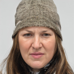 Joyful white adult female with long  brown hair and grey eyes