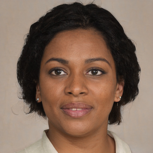 Joyful black young-adult female with medium  black hair and brown eyes