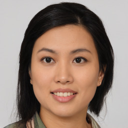 Joyful asian young-adult female with medium  brown hair and brown eyes