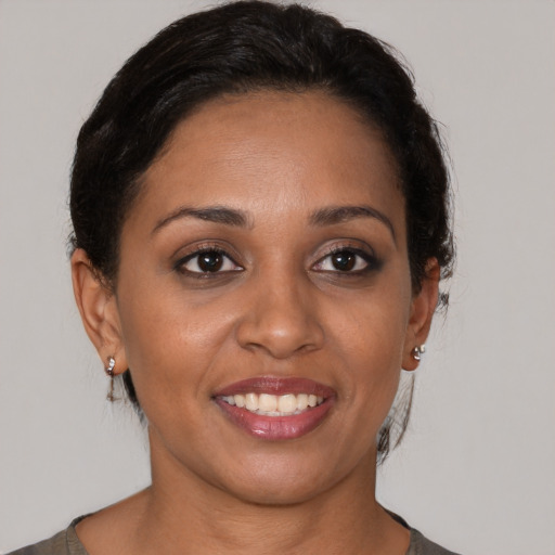 Joyful black young-adult female with short  brown hair and brown eyes