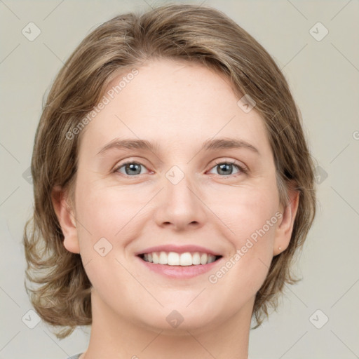 Joyful white young-adult female with medium  brown hair and green eyes