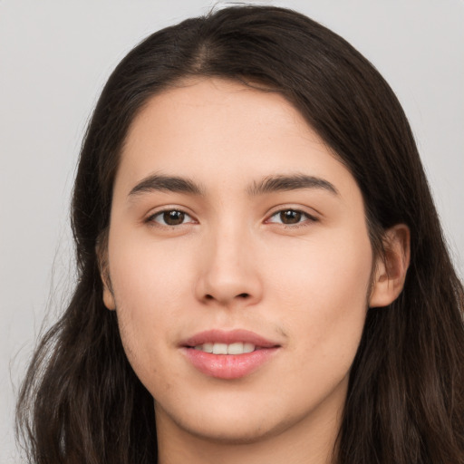 Joyful white young-adult female with long  brown hair and brown eyes