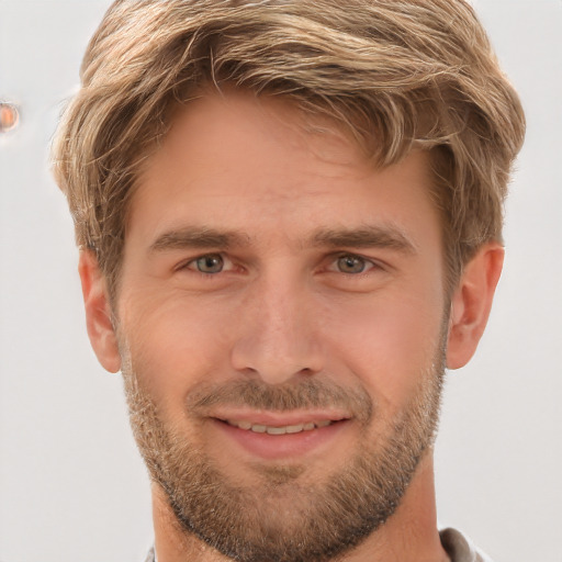 Joyful white young-adult male with short  brown hair and grey eyes