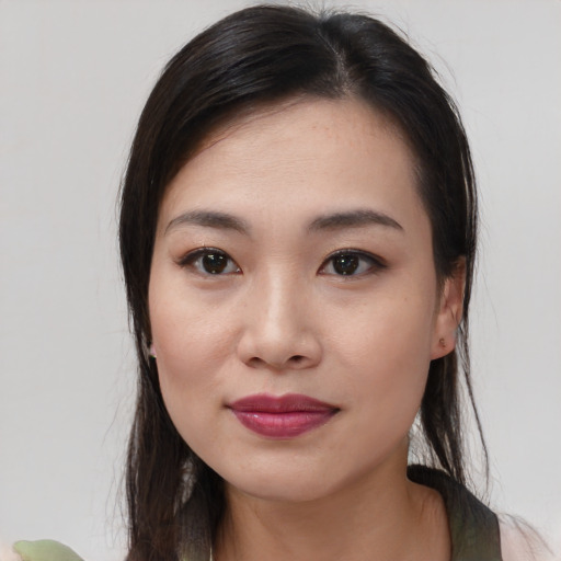 Joyful asian young-adult female with medium  brown hair and brown eyes