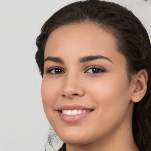 Joyful white young-adult female with long  brown hair and brown eyes