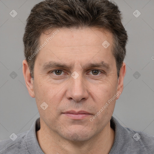 Joyful white adult male with short  brown hair and grey eyes