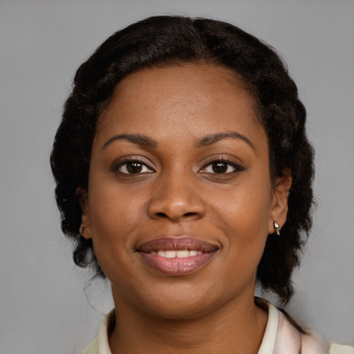 Joyful black young-adult female with medium  brown hair and brown eyes