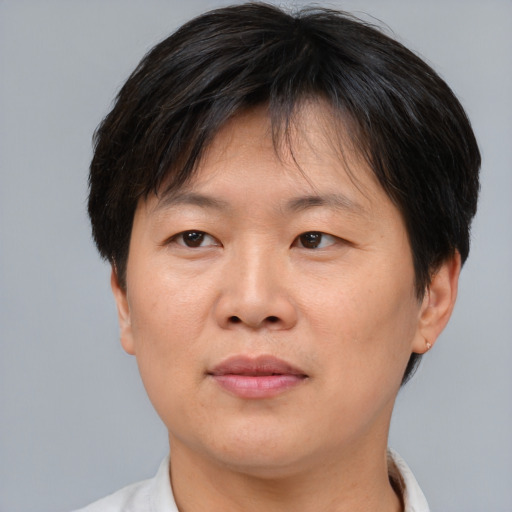 Joyful asian adult female with short  brown hair and brown eyes