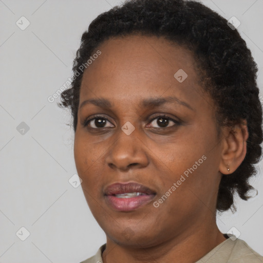 Joyful black adult female with short  brown hair and brown eyes