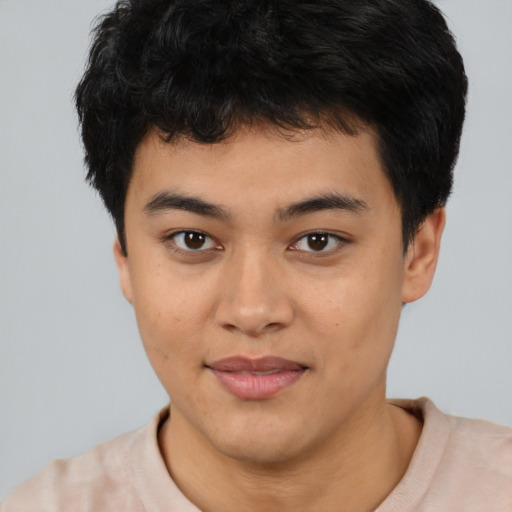 Joyful asian young-adult male with short  brown hair and brown eyes