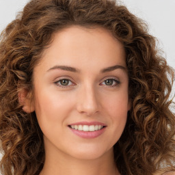 Joyful white young-adult female with long  brown hair and green eyes