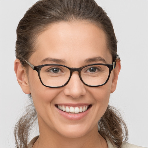 Joyful white young-adult female with medium  brown hair and brown eyes