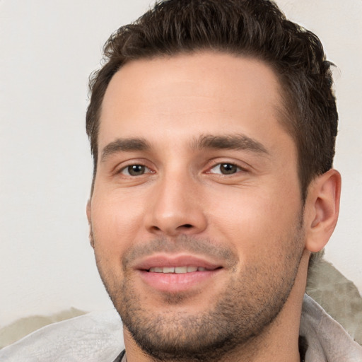 Joyful white young-adult male with short  brown hair and brown eyes