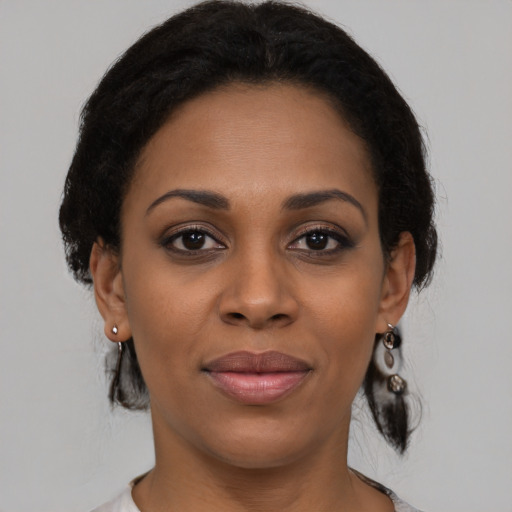 Joyful black young-adult female with medium  brown hair and brown eyes