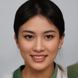 Joyful asian young-adult female with short  brown hair and brown eyes