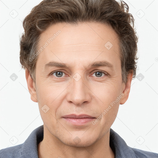 Joyful white adult male with short  brown hair and grey eyes