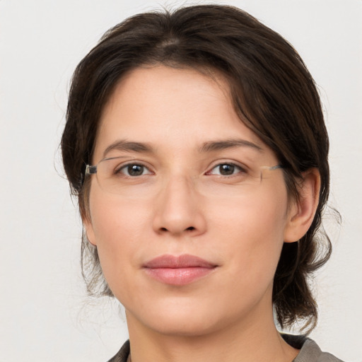 Joyful white young-adult female with medium  brown hair and brown eyes