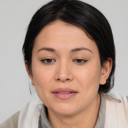 Joyful white young-adult female with medium  black hair and brown eyes