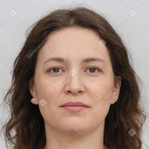 Joyful white adult female with long  brown hair and brown eyes