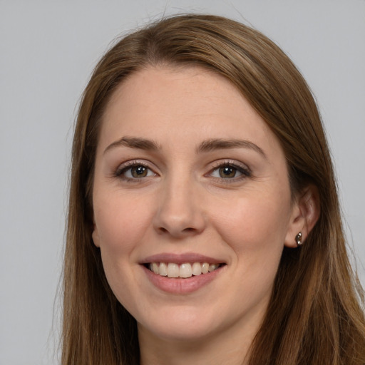 Joyful white young-adult female with long  brown hair and grey eyes