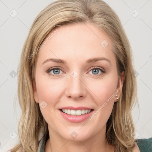 Joyful white young-adult female with long  brown hair and green eyes