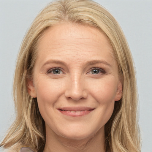 Joyful white adult female with long  brown hair and brown eyes