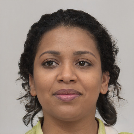 Joyful black young-adult female with medium  brown hair and brown eyes