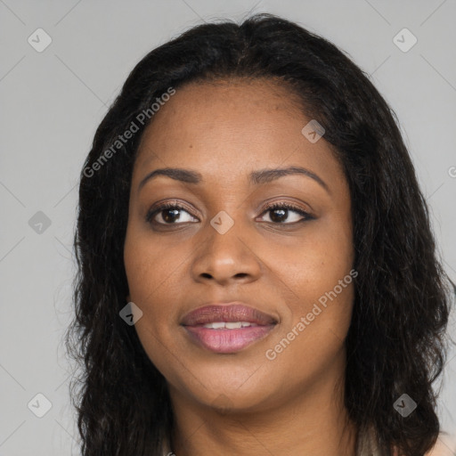 Joyful black young-adult female with long  black hair and brown eyes